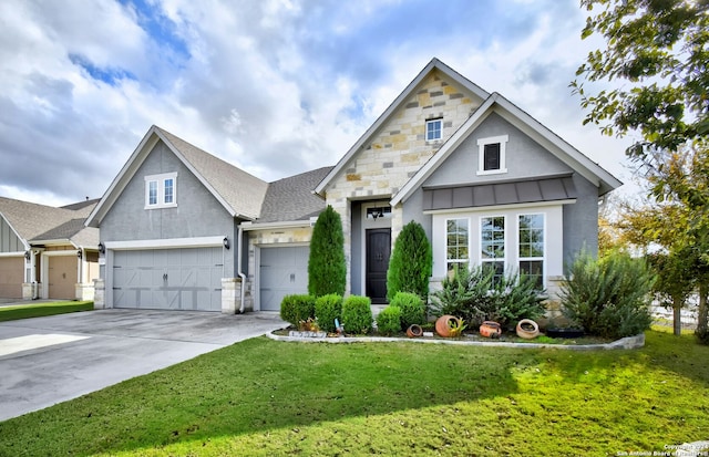 view of front of property featuring a front yard and a garage