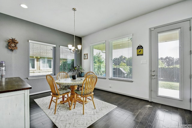 dining area with a notable chandelier and dark wood-type flooring