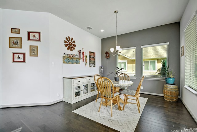 dining space with dark hardwood / wood-style flooring and a notable chandelier