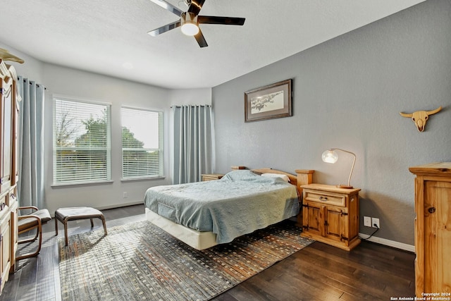 bedroom with ceiling fan and dark wood-type flooring