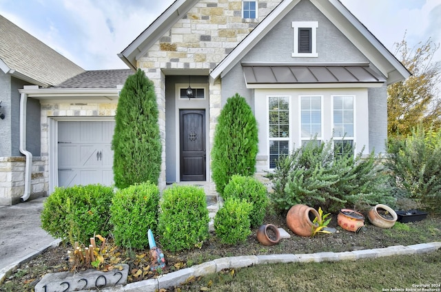 view of exterior entry with a garage