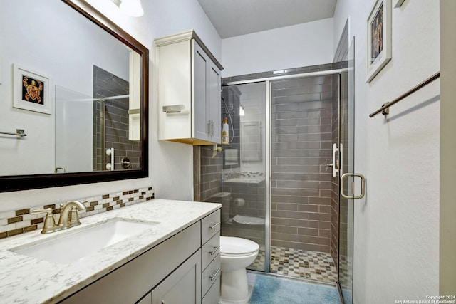 bathroom with tile patterned floors, an enclosed shower, toilet, decorative backsplash, and vanity