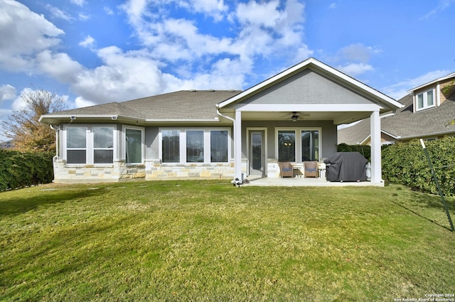 back of property featuring ceiling fan, a yard, and a patio