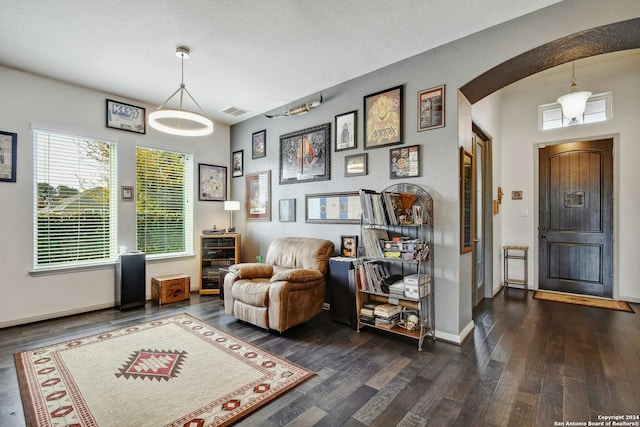 sitting room with a textured ceiling, beverage cooler, and dark hardwood / wood-style floors