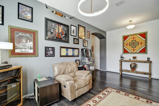 sitting room with dark hardwood / wood-style flooring