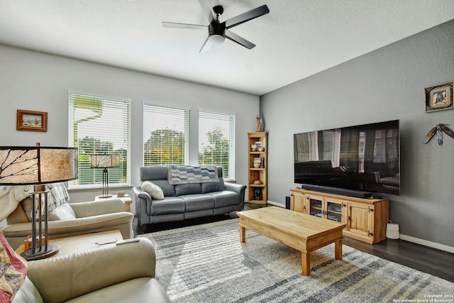 living room with dark hardwood / wood-style floors and ceiling fan