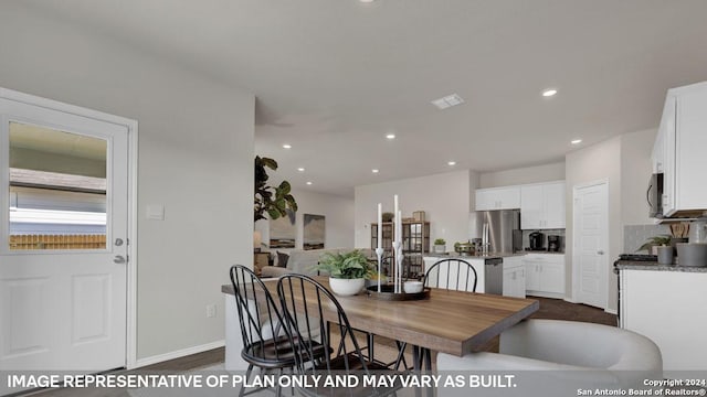 dining area featuring dark wood-type flooring