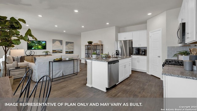 kitchen with white cabinets, stainless steel appliances, dark hardwood / wood-style floors, and an island with sink