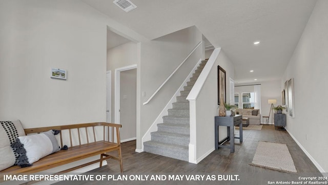 staircase with wood-type flooring