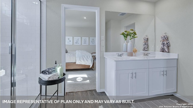 bathroom with vanity, wood-type flooring, and a shower with shower door