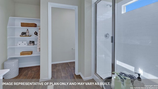 bathroom with an enclosed shower and hardwood / wood-style flooring