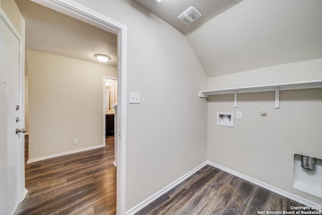 clothes washing area featuring a textured ceiling, hookup for a gas dryer, hookup for a washing machine, and dark hardwood / wood-style floors