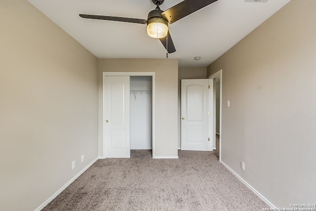 unfurnished bedroom with ceiling fan, light colored carpet, and a closet