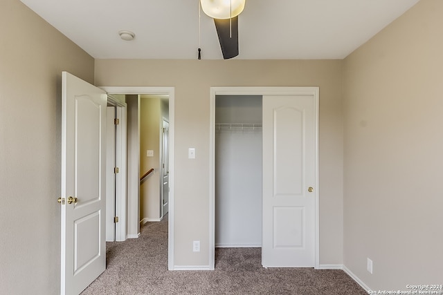 unfurnished bedroom with ceiling fan, a closet, and carpet floors