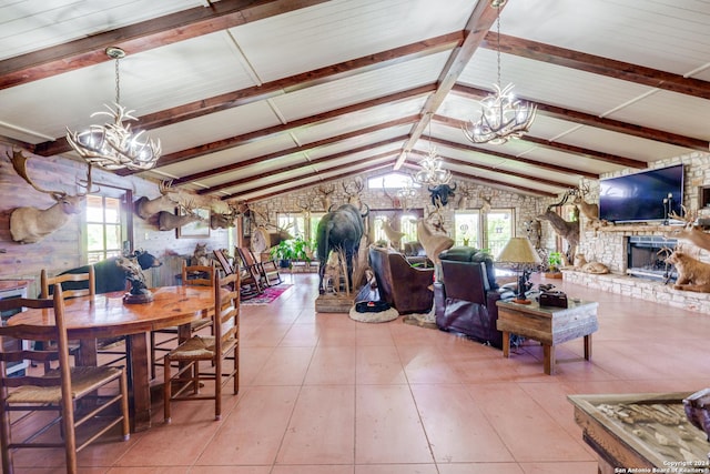 tiled dining space with a stone fireplace, lofted ceiling with beams, and an inviting chandelier