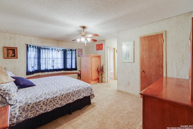 bedroom featuring light carpet, a textured ceiling, and ceiling fan