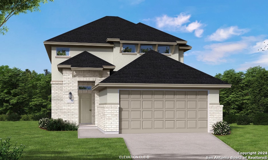 view of front of property with a front yard and a garage