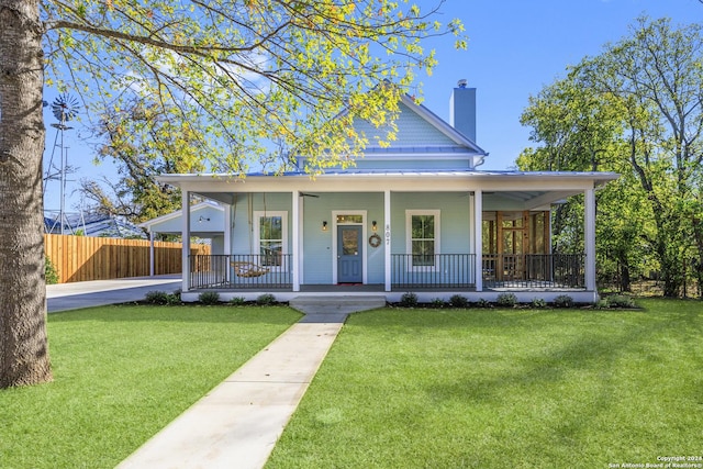 farmhouse inspired home with covered porch and a front yard