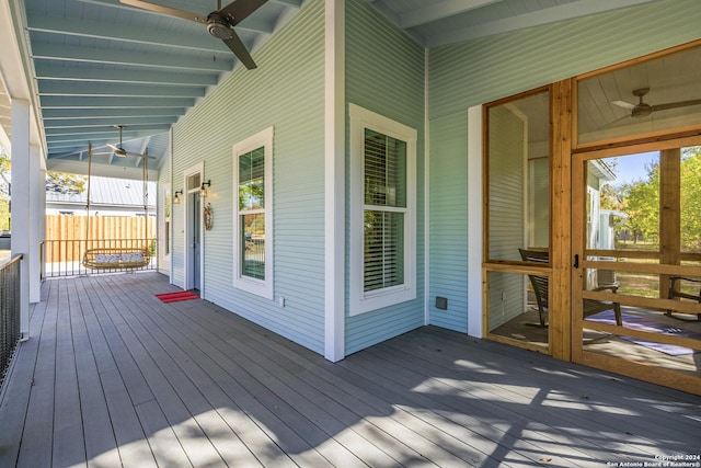 wooden deck featuring covered porch and ceiling fan