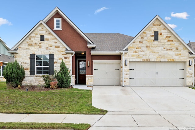 craftsman-style house featuring a garage and a front yard