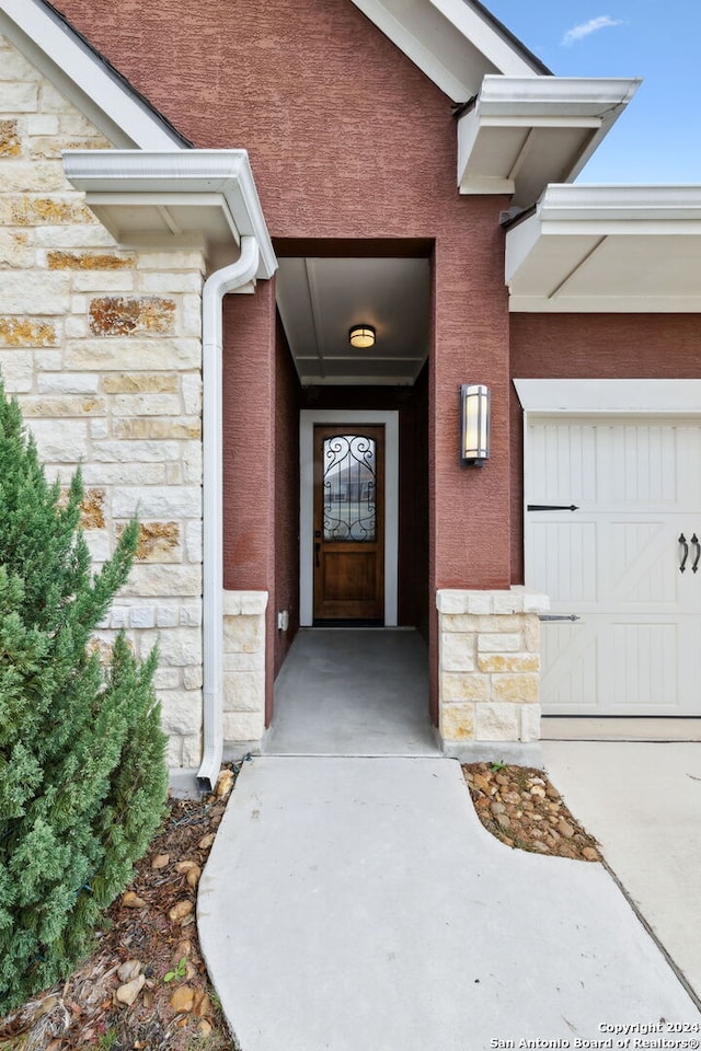 view of exterior entry with a garage