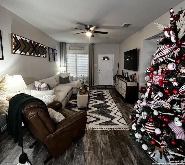 living room featuring ceiling fan and dark hardwood / wood-style floors