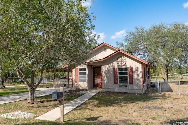 bungalow-style home with a front yard