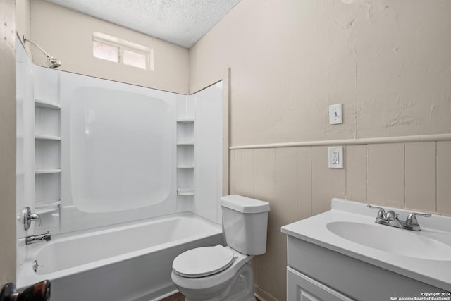 full bathroom featuring vanity, a textured ceiling, bathing tub / shower combination, and toilet