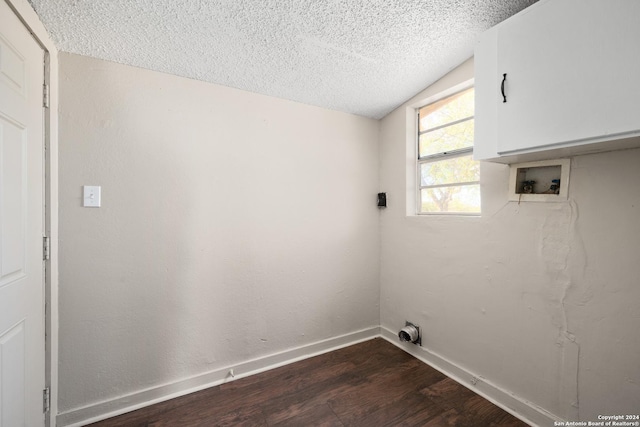 washroom with washer hookup, a textured ceiling, and dark wood-type flooring