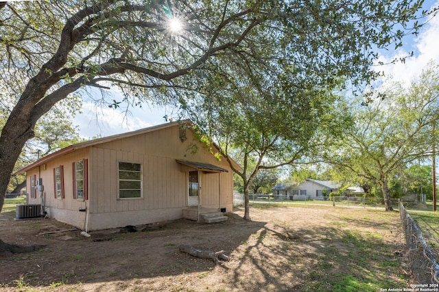 view of side of home with cooling unit