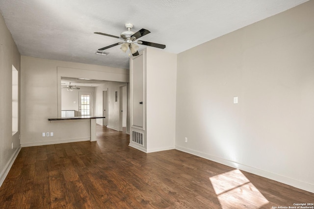 spare room featuring a textured ceiling, dark hardwood / wood-style flooring, and ceiling fan