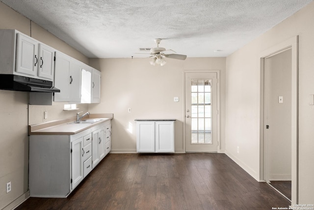 kitchen with a textured ceiling, ceiling fan, sink, dark hardwood / wood-style floors, and white cabinetry