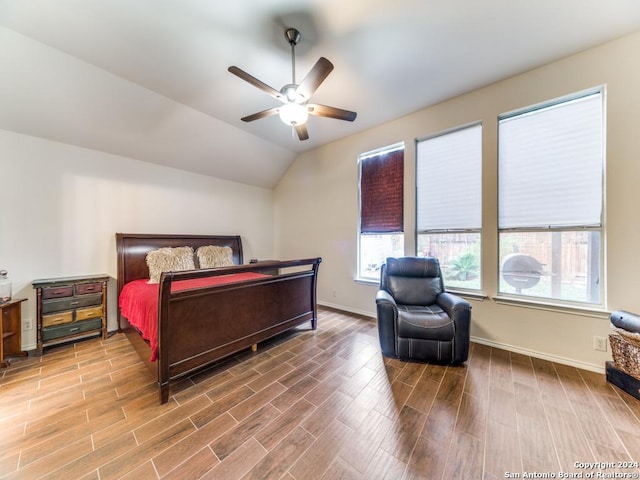 bedroom with ceiling fan, hardwood / wood-style floors, and lofted ceiling