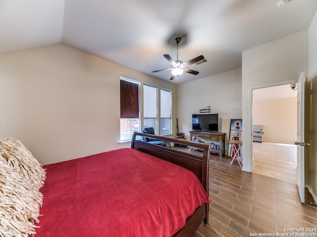 bedroom featuring ceiling fan, lofted ceiling, and hardwood / wood-style flooring