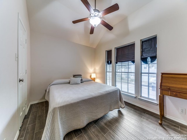 bedroom featuring ceiling fan, dark hardwood / wood-style floors, and vaulted ceiling