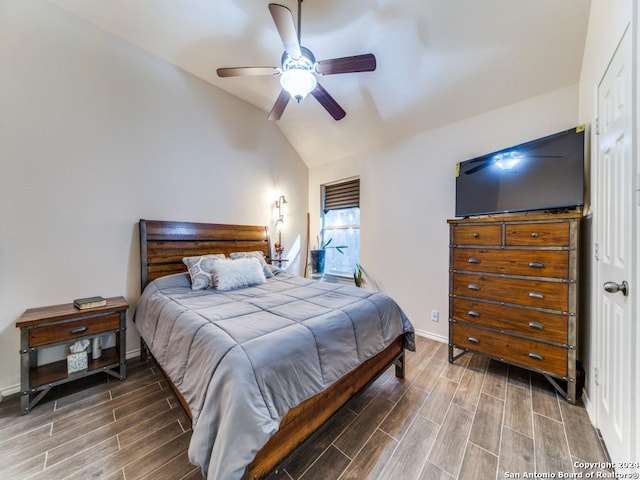 bedroom featuring wood-type flooring, vaulted ceiling, and ceiling fan