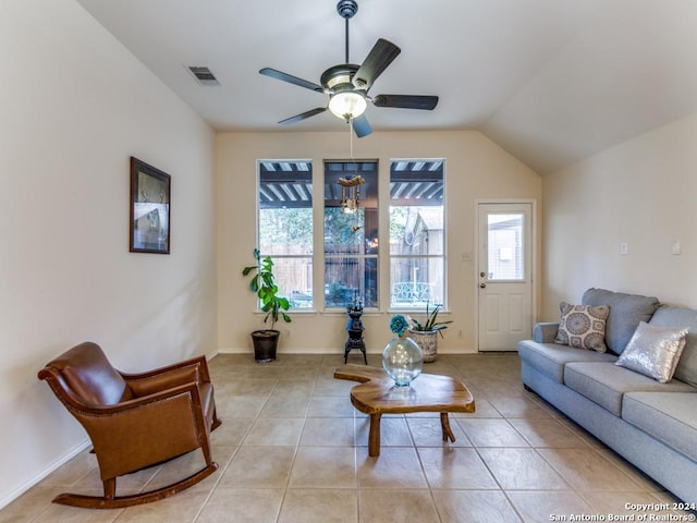 tiled living room featuring ceiling fan and lofted ceiling