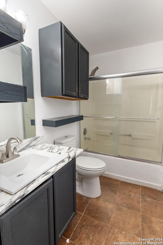 full bathroom with vanity, toilet, and enclosed tub / shower combo