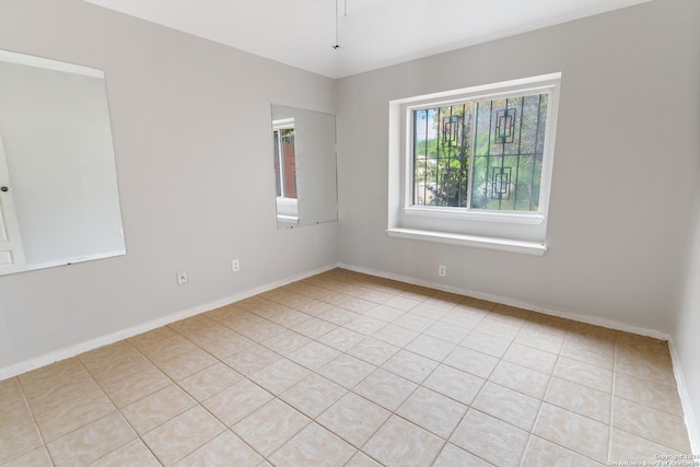 spare room featuring light tile patterned floors