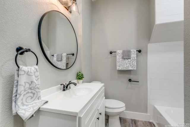 bathroom featuring hardwood / wood-style flooring, vanity, and toilet