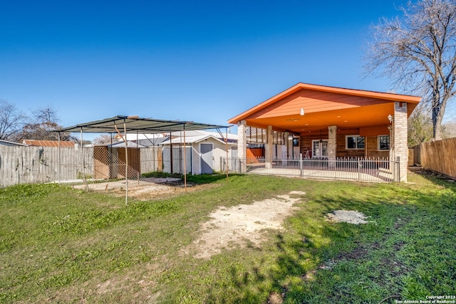 rear view of house featuring a yard and a patio