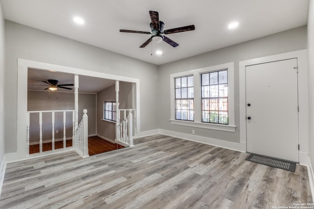 foyer with ceiling fan and light hardwood / wood-style floors