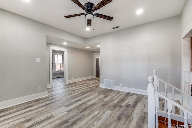 unfurnished room with ceiling fan and light wood-type flooring