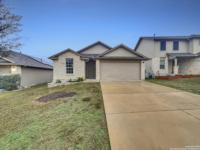 view of front of home with a front lawn and a garage