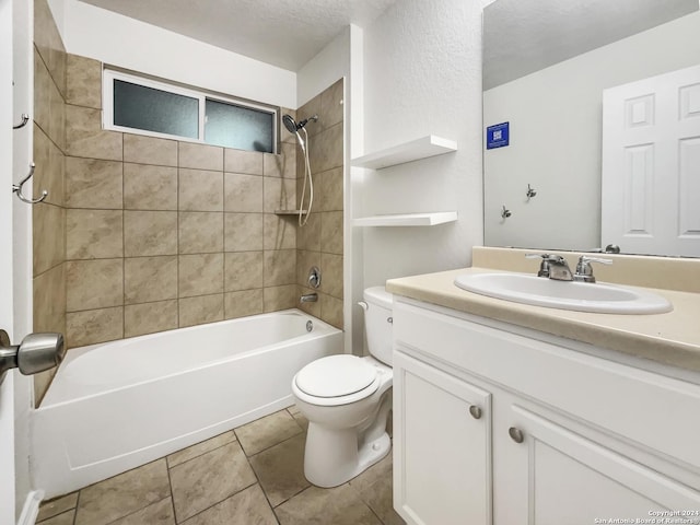 full bathroom with vanity, tiled shower / bath, tile patterned flooring, toilet, and a textured ceiling