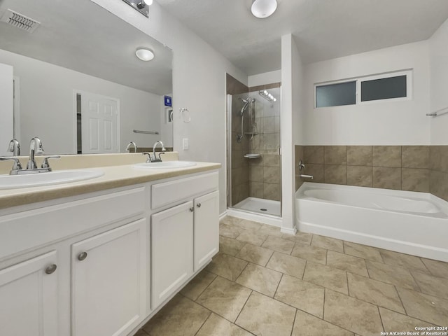 bathroom featuring shower with separate bathtub and vanity