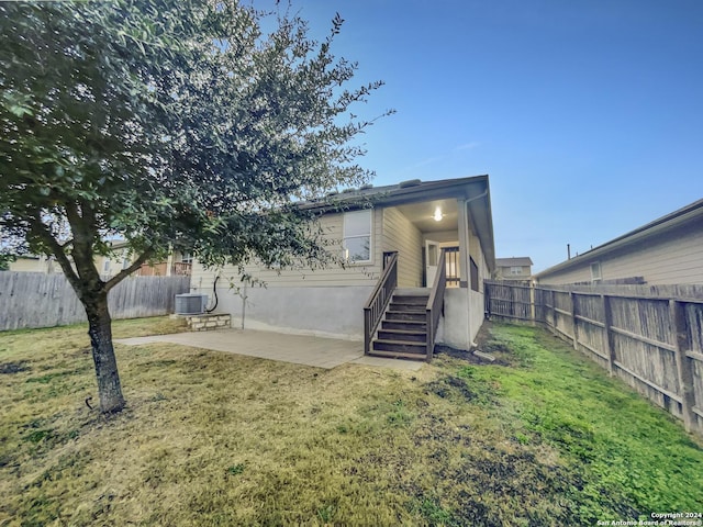 exterior space with a yard, a patio, and central AC