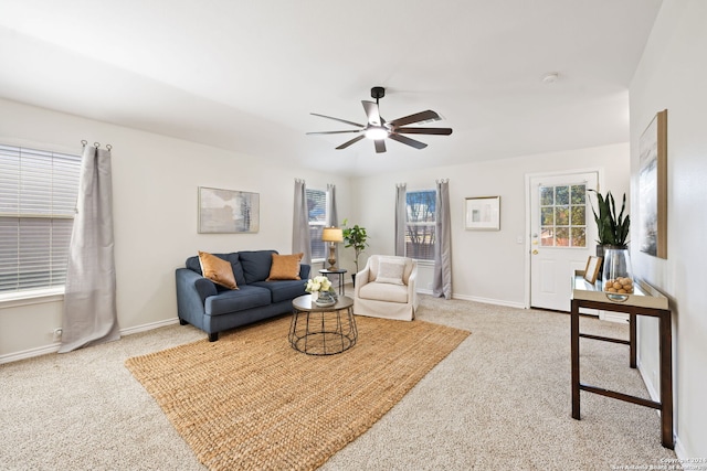 carpeted living room featuring ceiling fan