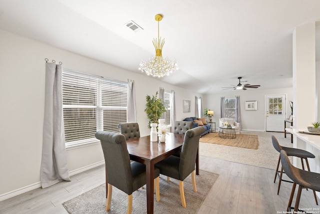 dining room featuring ceiling fan with notable chandelier and light wood-type flooring