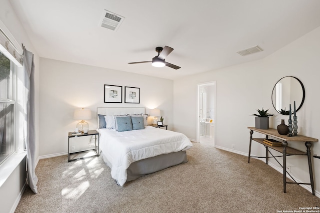 carpeted bedroom with connected bathroom and ceiling fan